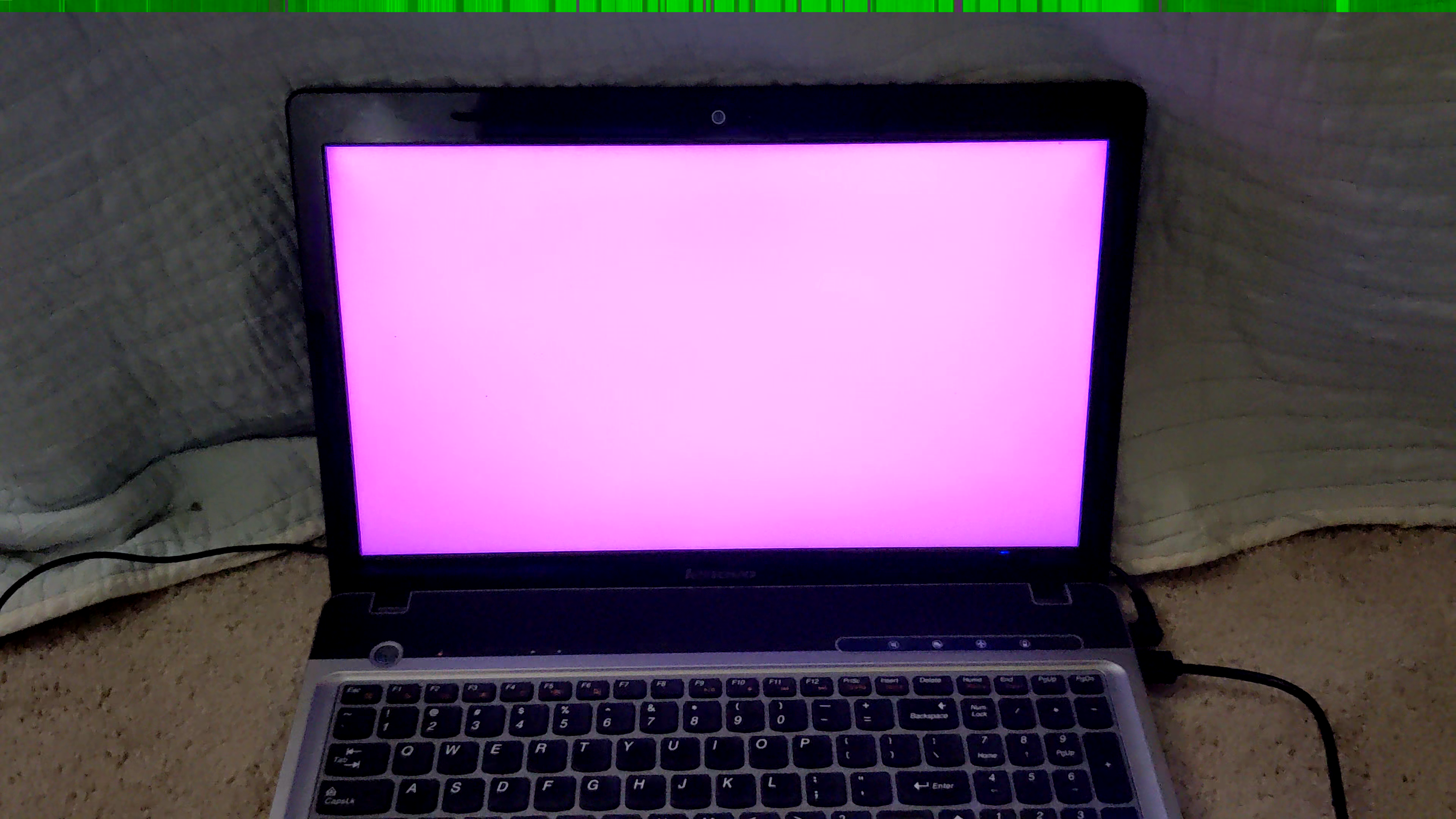 Picture of an old computer with a magenta screen